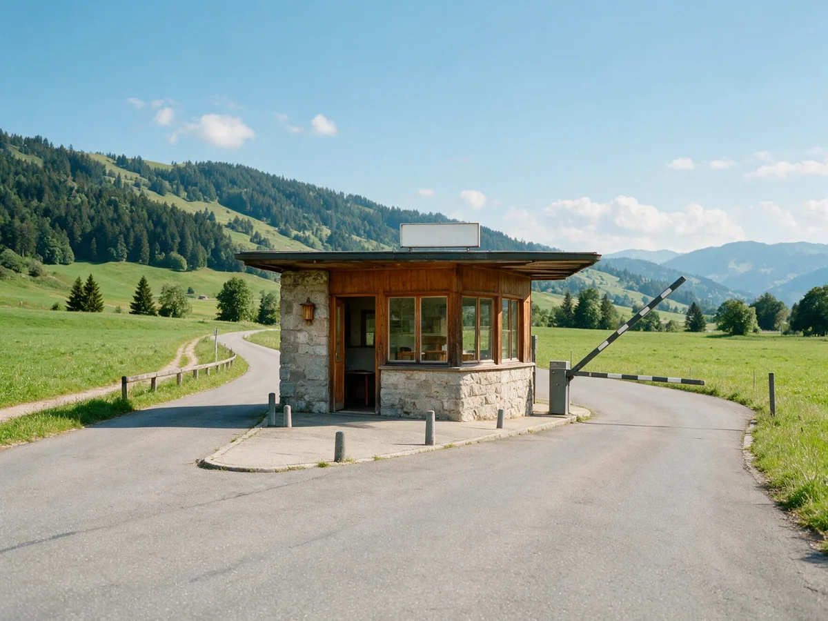 Customs post on a small country road, barrier raised, fields and hills